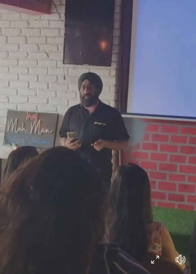 Jasminder presenting to a seated audience